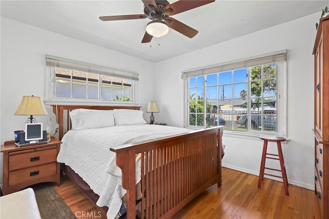 11900 Covello St, North Hollywood, CA 91605 - bedroom with baseboards, wood finished floors, and ceiling fan