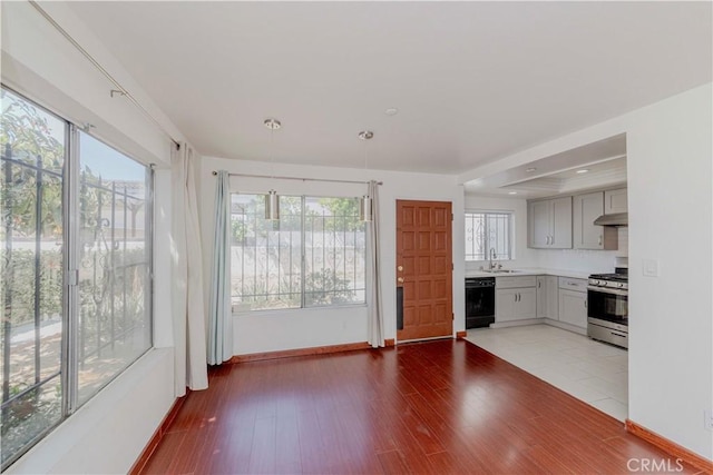 5021 Peck Rd Unit 9, El Monte, CA 91732 - kitchen with stainless steel gas range oven, dishwasher, under cabinet range hood, a sink, and healthy amount of natural light