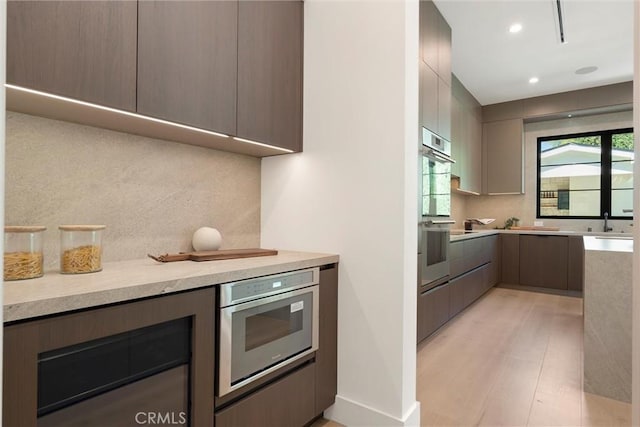 4625 Vesper Ave, Sherman Oaks, CA 91403 - kitchen featuring decorative backsplash, modern cabinets, light wood-style floors, recessed lighting, and double oven