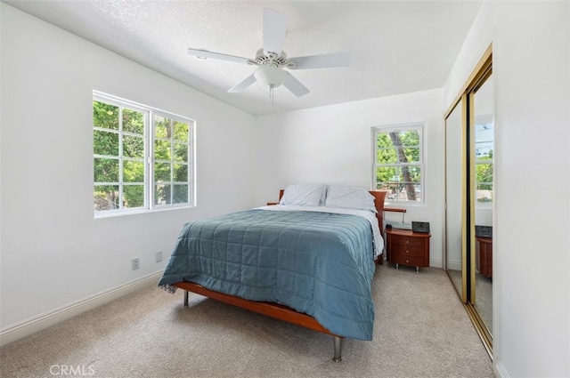 4950 Dunman Ave, Woodland Hills, CA 91364 - bedroom with light colored carpet, a closet, ceiling fan, and baseboards