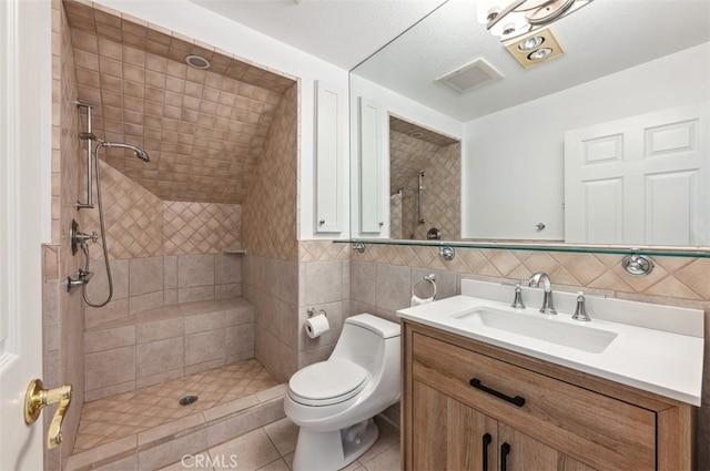 4950 Dunman Ave, Woodland Hills, CA 91364 - full bathroom featuring vanity, a tile shower, toilet, tile walls, and tile patterned floors
