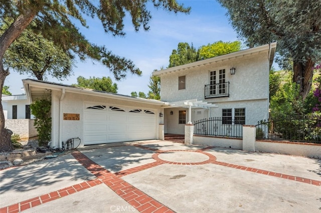 4950 Dunman Ave, Woodland Hills, CA 91364 - view of front of house featuring stucco siding, driveway, and an attached garage