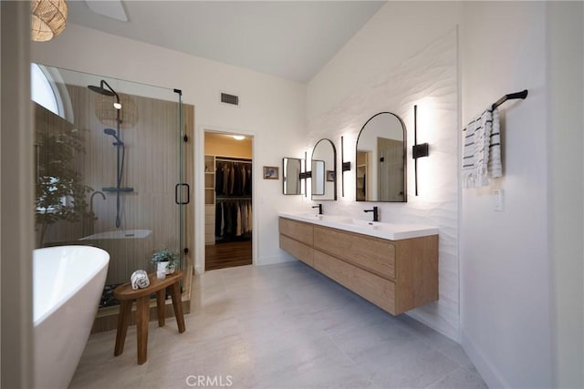 2902 Easton Pl, Rowland Heights, CA 91748 - bathroom featuring a tile shower, a freestanding bath, double vanity, a walk in closet, and baseboards