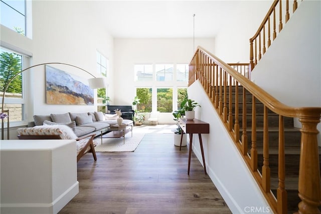 2902 Easton Pl, Rowland Heights, CA 91748 - living area featuring a high ceiling, plenty of natural light, stairway, wood finished floors, and baseboards