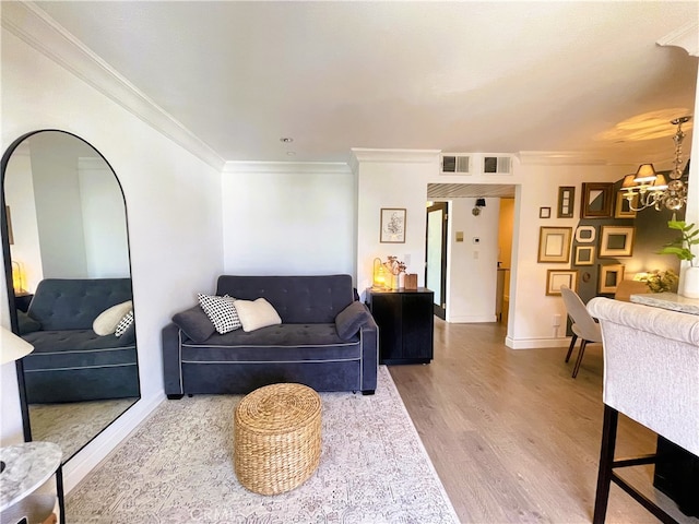 10960 Ashton Ave Unit 307, Los Angeles, CA 90024 - living room with wood finished floors, a chandelier, and crown molding