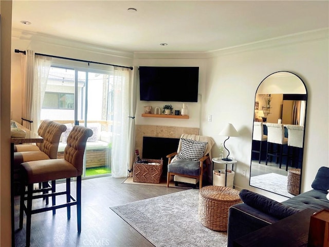 10960 Ashton Ave Unit 307, Los Angeles, CA 90024 - living room featuring crown molding, wood finished floors, and a tile fireplace
