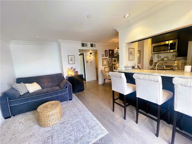 10960 Ashton Ave Unit 307, Los Angeles, CA 90024 - living area with crown molding and light wood-style floors