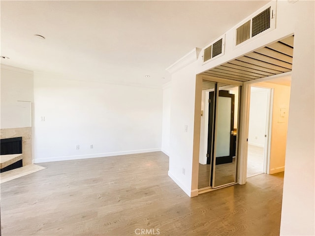 10960 Ashton Ave Unit 307, Los Angeles, CA 90024 - unfurnished living room featuring ornamental molding, wood finished floors, and a premium fireplace