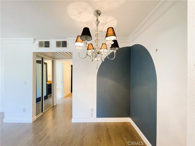 10960 Ashton Ave Unit 307, Los Angeles, CA 90024 - empty room with ornamental molding, arched walkways, wood finished floors, and a chandelier