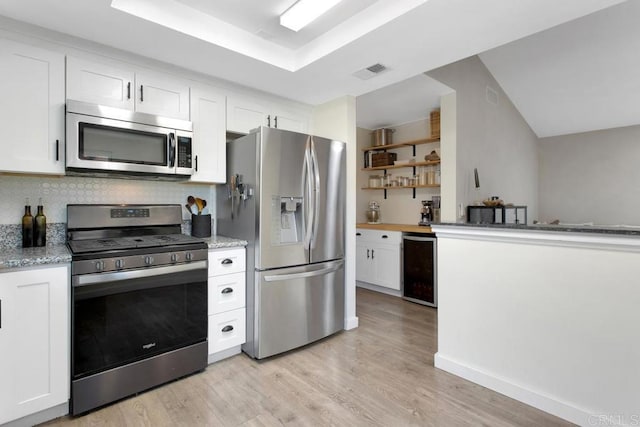 4736 Dalea Pl, Oceanside, CA 92057 - kitchen featuring appliances with stainless steel finishes, beverage cooler, white cabinetry, light wood-style floors, and tasteful backsplash