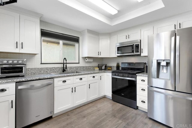 4736 Dalea Pl, Oceanside, CA 92057 - kitchen featuring appliances with stainless steel finishes, a sink, a raised ceiling, and white cabinetry