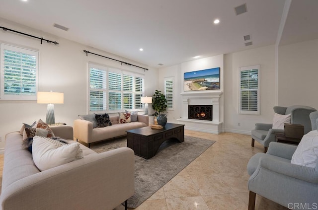 7845 Caminito Camelia, San Diego, CA 92127 - living area with a lit fireplace, recessed lighting, light tile patterned floors, and baseboards