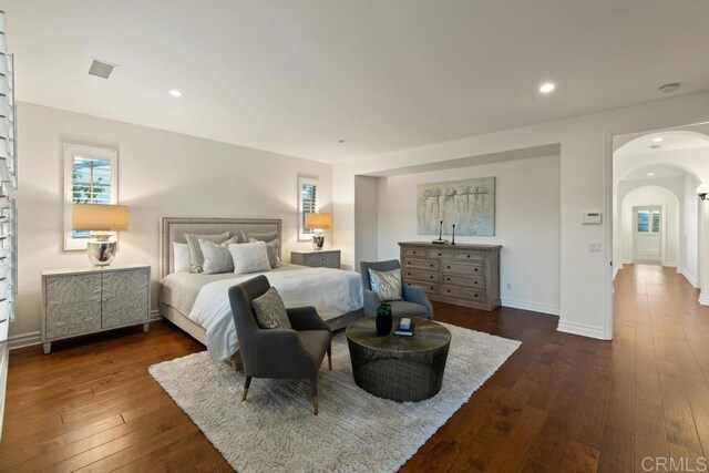 7845 Caminito Camelia, San Diego, CA 92127 - bedroom featuring arched walkways, dark wood-type flooring, recessed lighting, and baseboards