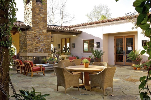 7845 Caminito Camelia, San Diego, CA 92127 - view of patio / terrace with french doors, outdoor dining space, and an outdoor living space with a fireplace