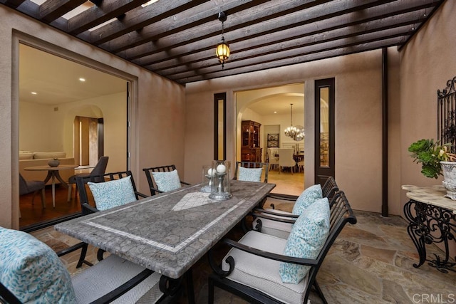 7845 Caminito Camelia, San Diego, CA 92127 - dining space with arched walkways, stone finish flooring, beamed ceiling, a chandelier, and recessed lighting