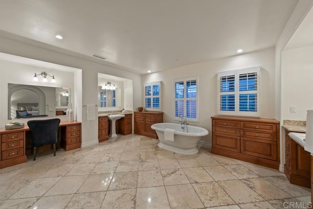 7845 Caminito Camelia, San Diego, CA 92127 - full bath featuring stone tile floors, a freestanding bath, vanity, baseboards, and recessed lighting