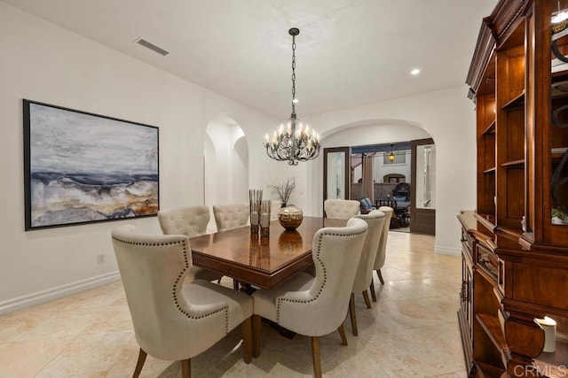 7845 Caminito Camelia, San Diego, CA 92127 - dining room with arched walkways, a chandelier, recessed lighting, and light tile patterned floors