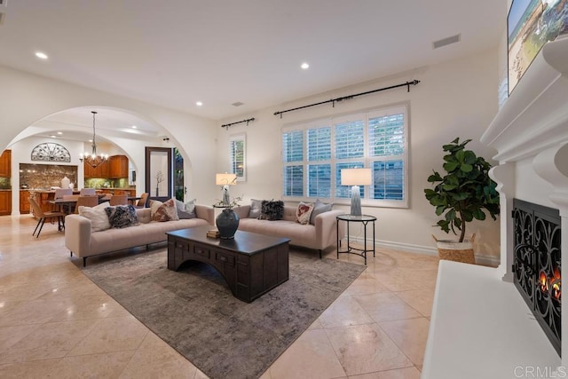 7845 Caminito Camelia, San Diego, CA 92127 - living room featuring arched walkways, a chandelier, recessed lighting, and light tile patterned floors