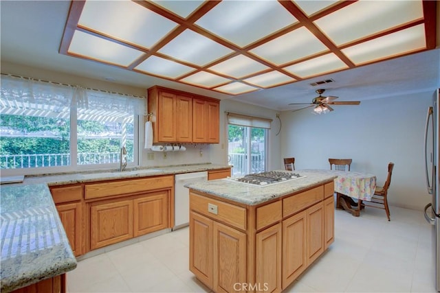 1375 San Gabriel Way, Merced, CA 95340 - kitchen featuring white appliances, a sink, light stone counters, and a kitchen island