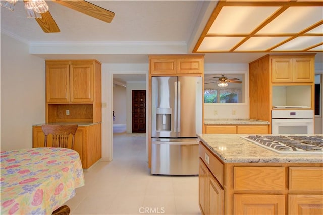 1375 San Gabriel Way, Merced, CA 95340 - kitchen with stainless steel appliances, a ceiling fan, light stone countertops, and crown molding