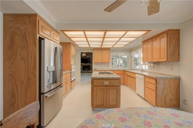 1375 San Gabriel Way, Merced, CA 95340 - kitchen with white appliances, light stone counters, a kitchen island, a sink, and crown molding