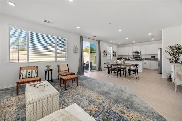 2544 Gunner Ridge Way, Rialto, CA 92377 - living room featuring recessed lighting, light wood-style floors, and baseboards