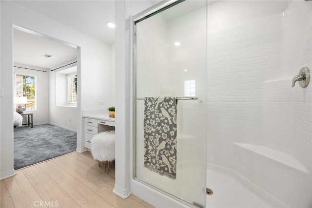 2544 Gunner Ridge Way, Rialto, CA 92377 - ensuite bathroom featuring a shower stall, wood finished floors, vanity, and baseboards