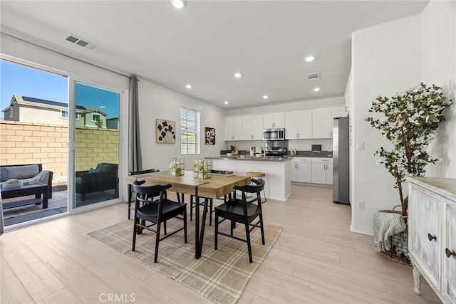 2544 Gunner Ridge Way, Rialto, CA 92377 - dining room with light wood-style flooring, recessed lighting, and baseboards