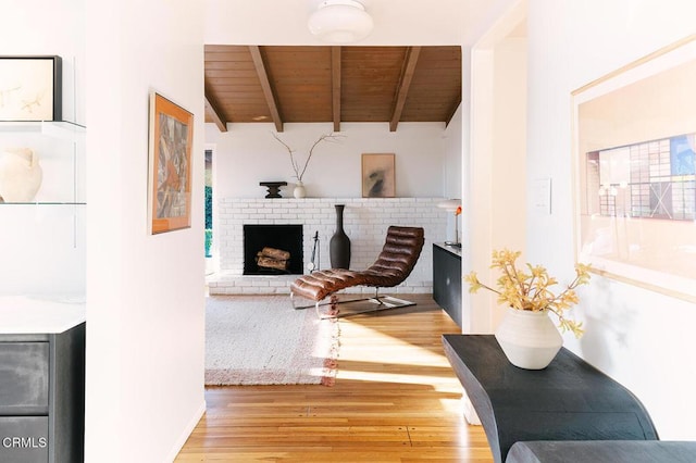 15845 Lassen St, North Hills, CA 91343 - living room with wooden ceiling with exposed beams, wood finished floors, and a brick fireplace