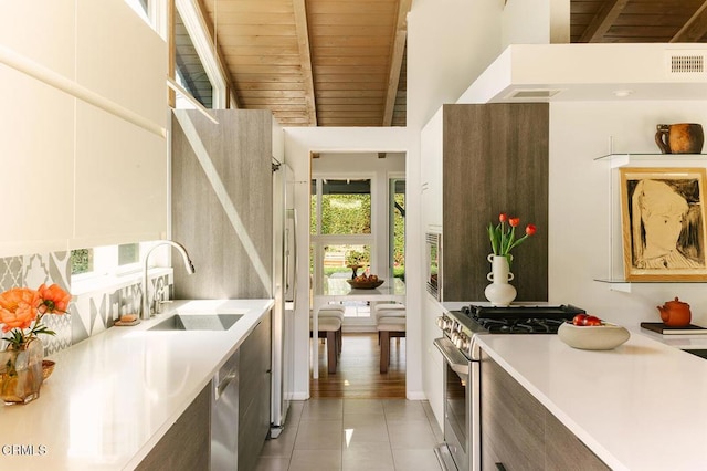 15845 Lassen St, North Hills, CA 91343 - kitchen with appliances with stainless steel finishes, a sink, light tile patterned floors, light countertops, and wood ceiling