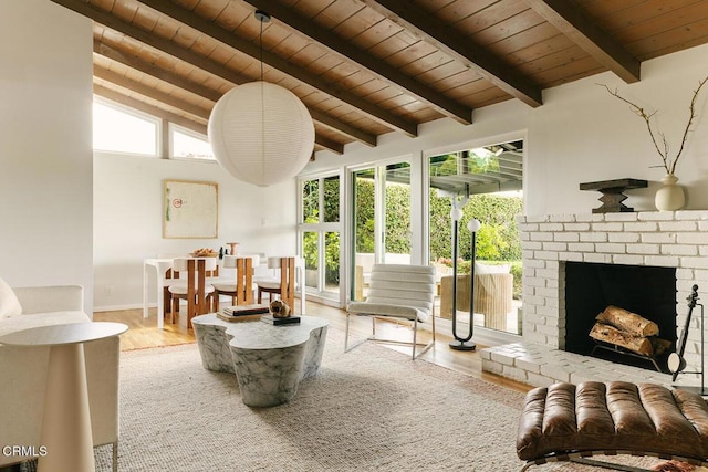 15845 Lassen St, North Hills, CA 91343 - living area featuring wood ceiling, wood finished floors, plenty of natural light, baseboards, and a brick fireplace