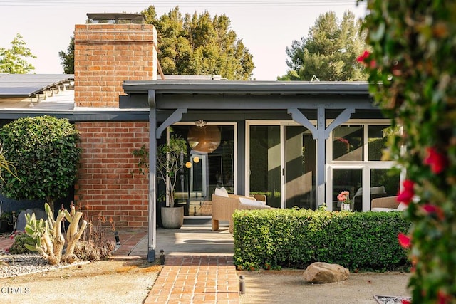 15845 Lassen St, North Hills, CA 91343 - doorway to property featuring a chimney and brick siding