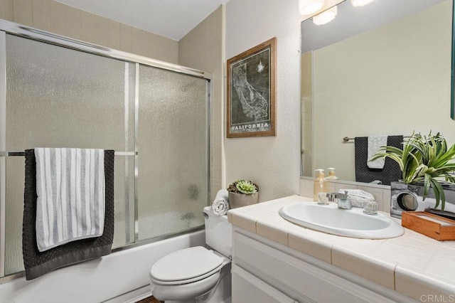 801 Kalpati Cir Unit B, Carlsbad, CA 92008 - bathroom featuring vanity, toilet, and bath / shower combo with glass door