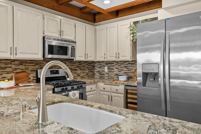 801 Kalpati Cir Unit B, Carlsbad, CA 92008 - kitchen featuring stainless steel appliances, beverage cooler, white cabinets, and coffered ceiling