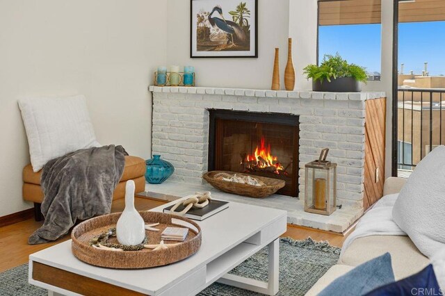 801 Kalpati Cir Unit B, Carlsbad, CA 92008 - sitting room featuring a fireplace and wood finished floors
