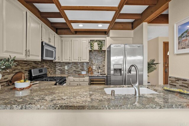801 Kalpati Cir Unit B, Carlsbad, CA 92008 - kitchen with appliances with stainless steel finishes, coffered ceiling, a sink, decorative backsplash, and beverage cooler
