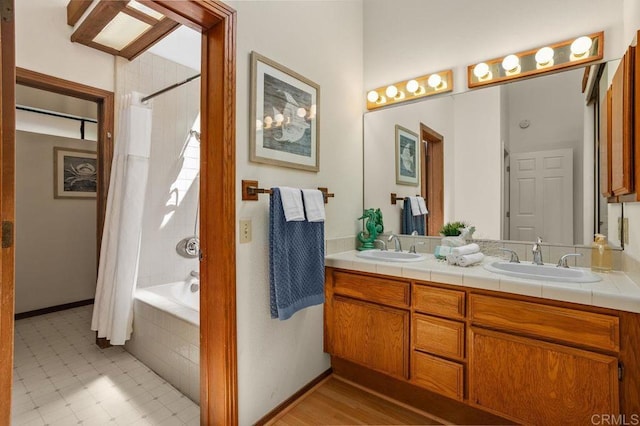 801 Kalpati Cir Unit B, Carlsbad, CA 92008 - bathroom with double vanity, tiled shower / bath combo, and baseboards