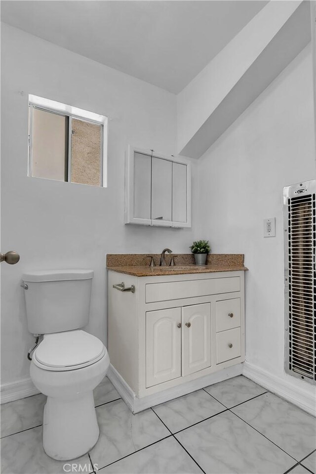 1144 Magnolia Ave, Gardena, CA 90247 - half bath featuring vanity, toilet, a heating unit, and baseboards