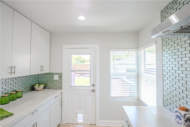 417 E 44th Way, Long Beach, CA 90807 - kitchen with light countertops, tasteful backsplash, white cabinetry, wall chimney exhaust hood, and recessed lighting