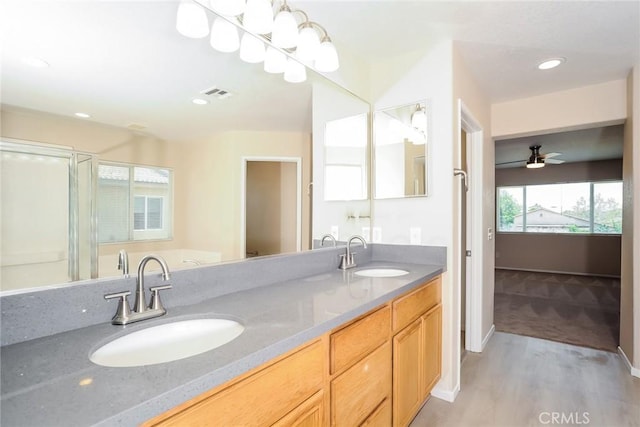 45529 36th St E, Lancaster, CA 93535 - full bathroom with wood finished floors, double vanity, a shower stall, baseboards, and ceiling fan