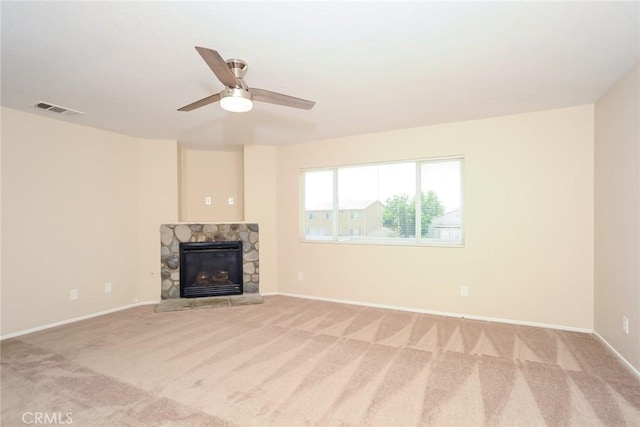 45529 36th St E, Lancaster, CA 93535 - unfurnished living room featuring light colored carpet, a stone fireplace, ceiling fan, and baseboards