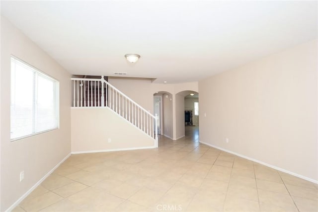 45529 36th St E, Lancaster, CA 93535 - spare room with arched walkways, stairway, and baseboards