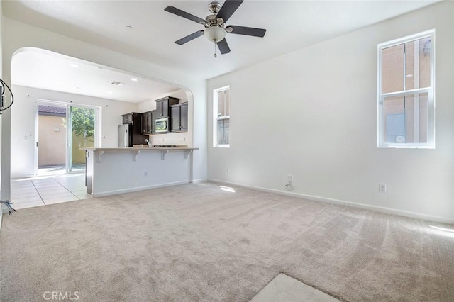 1587 N Strada Way, Clovis, CA 93619 - unfurnished living room with light carpet, a ceiling fan, and arched walkways