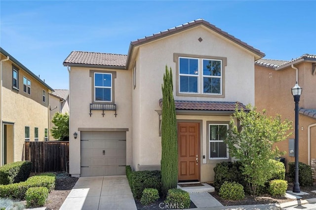 1587 N Strada Way, Clovis, CA 93619 - view of front facade featuring a tiled roof, stucco siding, a garage, and concrete driveway