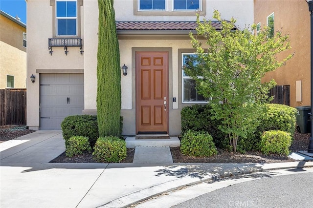 1587 N Strada Way, Clovis, CA 93619 - property entrance featuring an attached garage, stucco siding, and a tiled roof