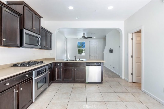 1587 N Strada Way, Clovis, CA 93619 - kitchen with appliances with stainless steel finishes, arched walkways, ceiling fan, a peninsula, and light countertops