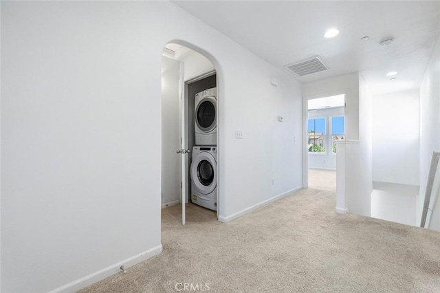 1587 N Strada Way, Clovis, CA 93619 - laundry room with stacked washer / dryer, arched walkways, light carpet, and recessed lighting