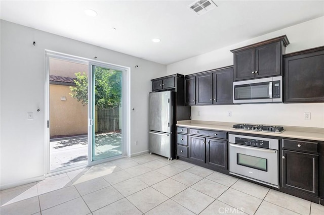1587 N Strada Way, Clovis, CA 93619 - kitchen featuring appliances with stainless steel finishes, light countertops, light tile patterned floors, and recessed lighting