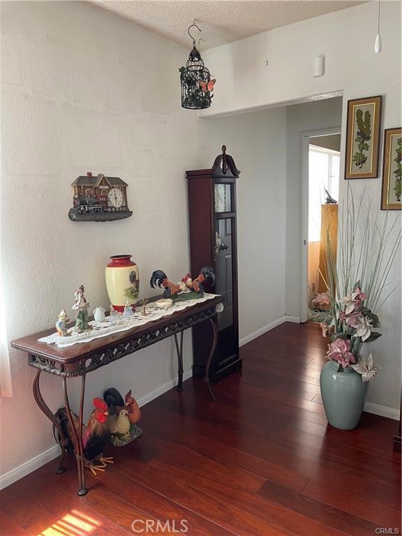 811 Walnut, Colton, CA 92324 - dining room featuring hardwood / wood-style flooring, baseboards, and a textured ceiling