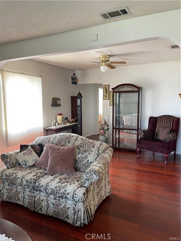 811 Walnut, Colton, CA 92324 - living area featuring wood finished floors, a ceiling fan, a textured ceiling, and arched walkways
